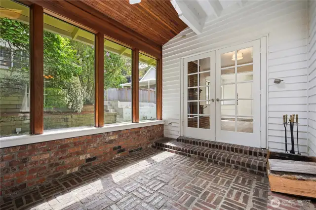 "Relax in the comfort of your sunroom while soaking in the serene beauty of your backyard."