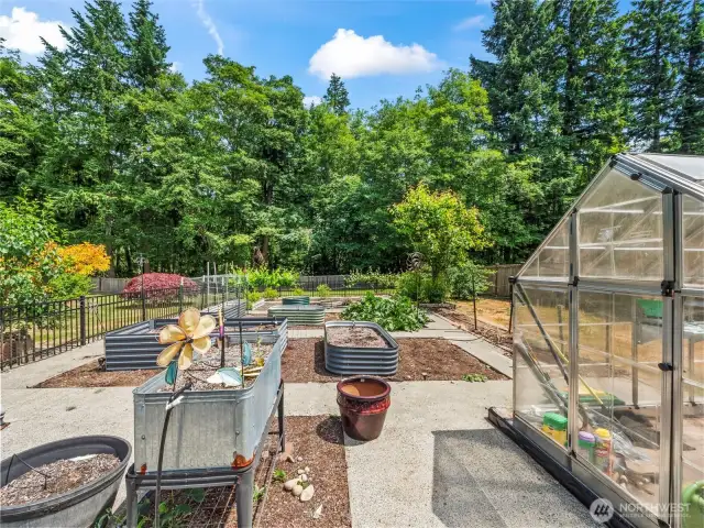 Raised garden beds and greenhouse convey!