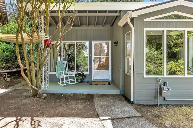 Covered front porch looks out toward the sound and Narrows Bridge.