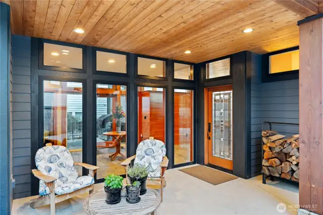 Covered entry with wall of glass create a seamless flow from exterior entry into the home. There are zero steps on the main level from access at the front door or garage into the home.