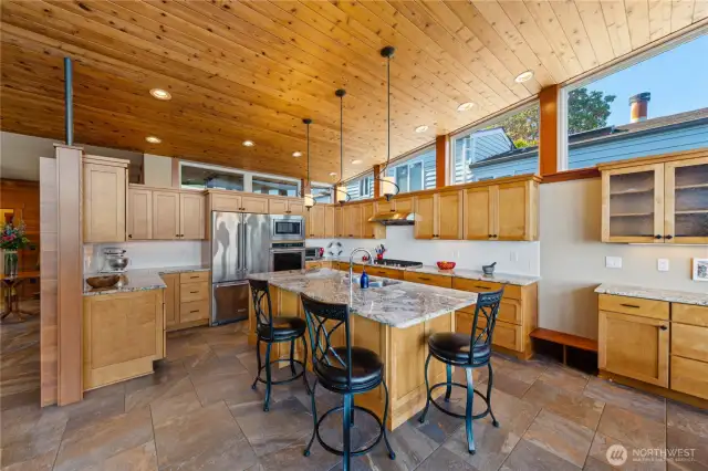 View back from the water side towards the kitchen with ample cabinet space and granite counters.