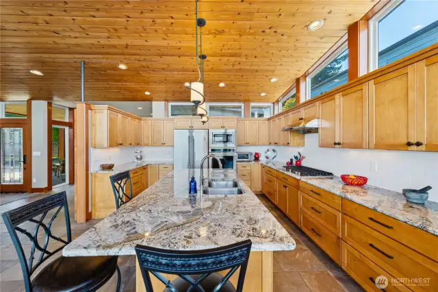 Custom upper windows above the cabinets create a feeling of a bright and open kitchen area.