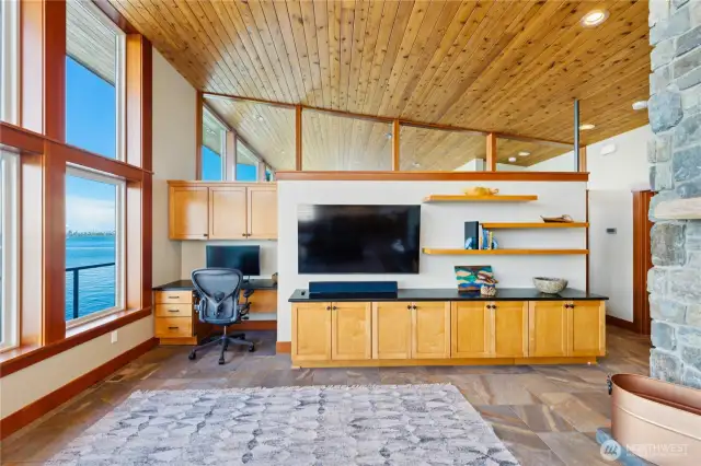 Custom built-ins at end of living room with additional cabinet/storage space and work space.