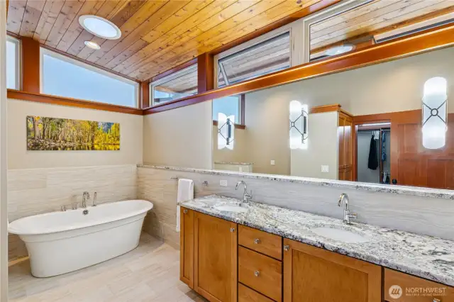 Elegant owner's bath with vessel tub and double vanity is connected to the owner's suite with a large walk-thru closet.