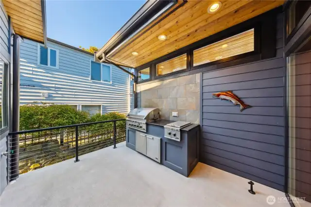 Patio space with built-in BBQ and outdoor kitchen is covered and perfect for year round use.