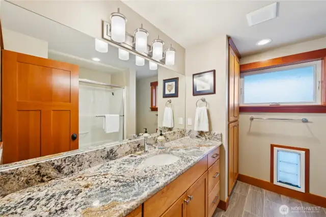 Lower level full bath with large counter and ample storage space.
