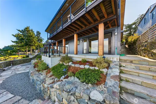 Stone retaining wall and steps on the waterside of the home.