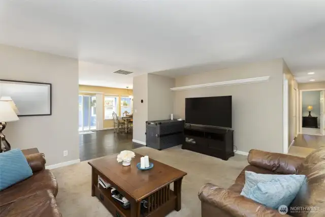 Main living room, hallway to front door and office (could be used as a bedroom) and primary suite.