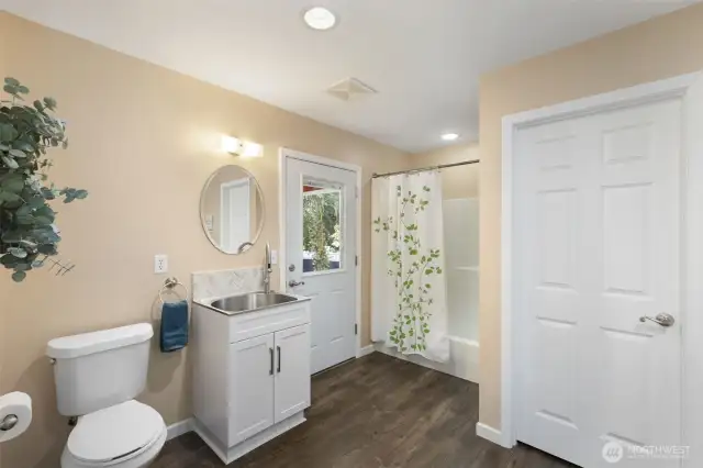 Main home laundry/large storage closet and full bath...exterior door leads to breezeway.