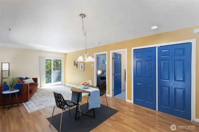 2nd home dining/living looking into primary bedroom, full bath and behind those 2 blue doors - laundry. Kitchen and other bedroom to the right out of shot.