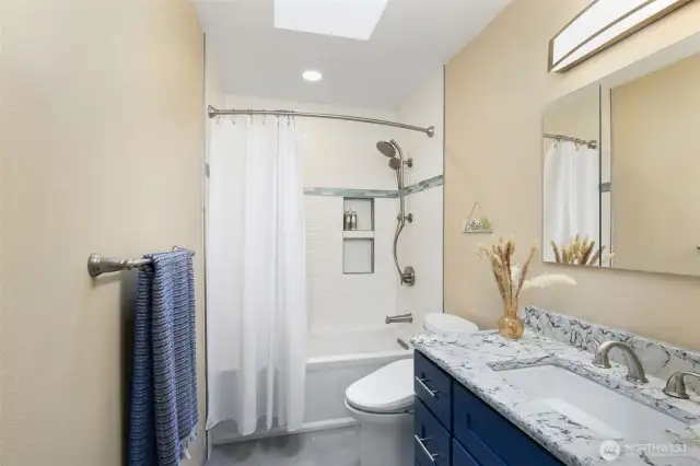 2nd home new bathroom...quartz counter, tiled shower/floor and skylight!