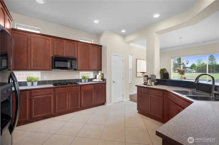 Large kitchen with gas range, upper and lower recipe windows.