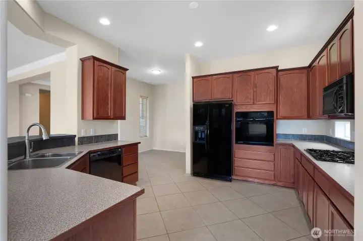 Large kitchen with gas range, upper and lower recipe windows.
