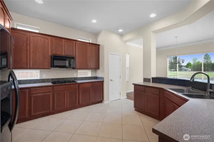 Large kitchen with gas range, upper and lower recipe windows.