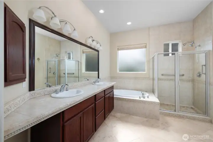 Primary bedroom and bathroom with gas fireplace, large closet and full tile shower.