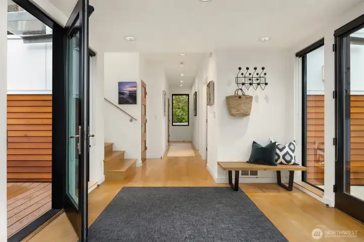 View to the bedroom wing with the front door to the right and garden deck to the left.
