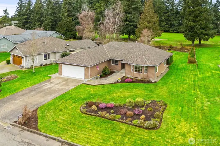 Aerial view showcasing the home's spacious lot, private setting, and proximity to the golf course setting.