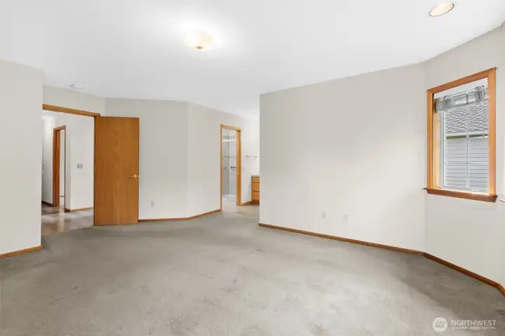 Alternate view of the primary bedroom showing entry to the ensuite bathroom.