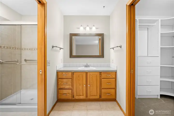 Primary ensuite with walk in shower, and adjacent walk in closet.