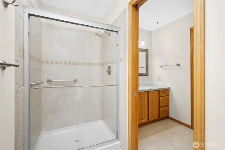 Primary bathroom, walk in shower with glass enclosure.
