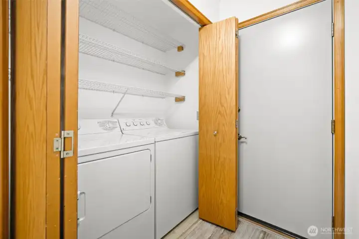 Laundry area with shelving and direct access to the attached 2 car garage.