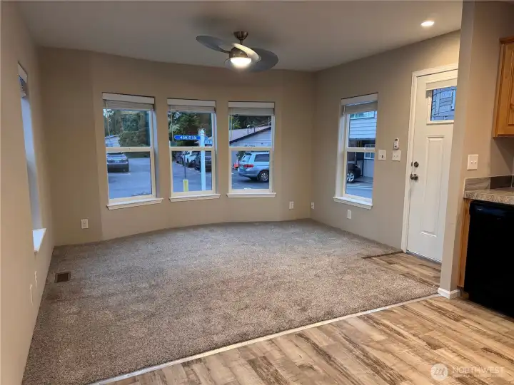 Bright, inviting living space with a wall of windows that fills the room with natural light and creates an open, airy feel.