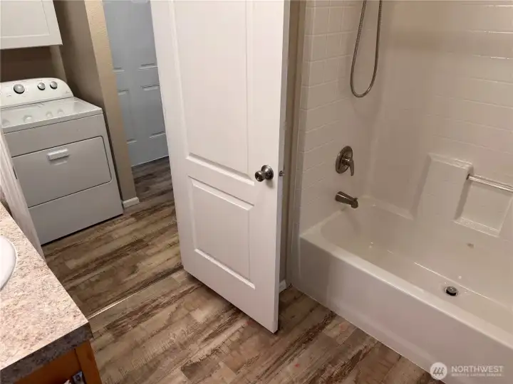 Full bath with tub/shower and convenient laundry access.