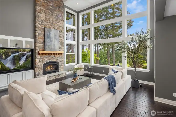 Floor to ceiling windows, 2 story stone fireplace, drenched in natural lighting