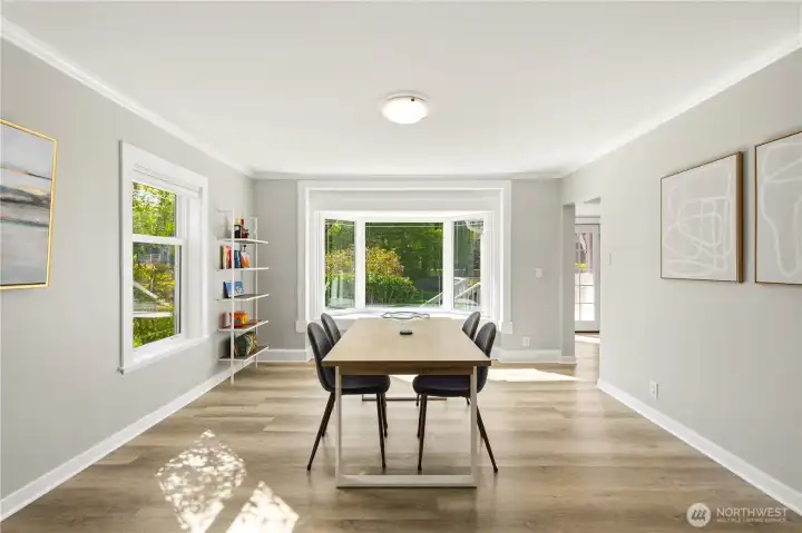 Formal dining room looking out to the gorgeous landscape in the backyard.