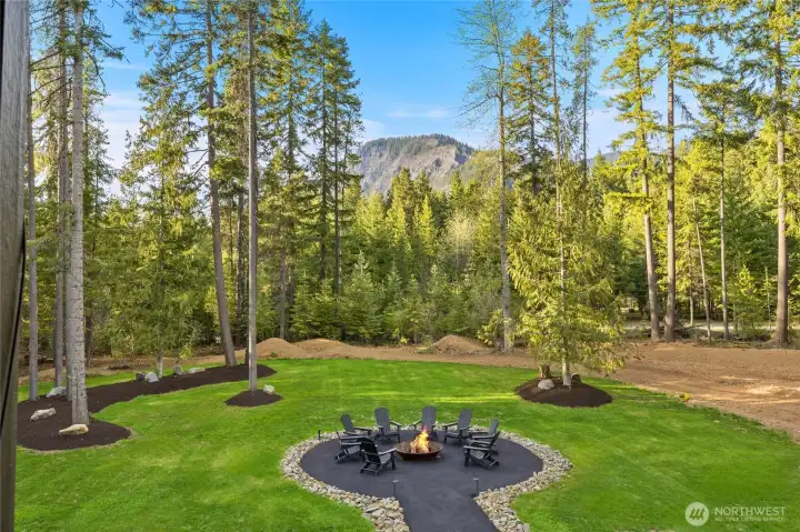 Exquisite yard with amazing views all around w/ mature trees surroundings. Large fire pit for entertaining.