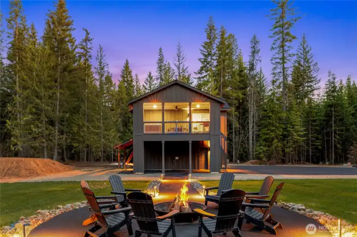 On the left you can see a jump from the dirt bike track surrounding this gem. The home has a large deck with a hot tub facing the stunning mountain views.