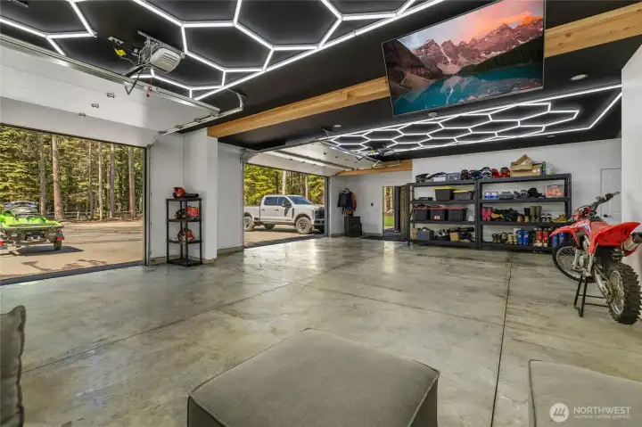 Check out this garage. Anyone would love the garage. It is finished like the inside of your home. It is sheetrocked and heated. Check out the cool lighting, too!