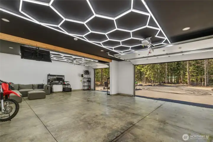 Another view of this massive garage. Plenty of room for all our toys. This location is perfect for outdoor enthusiast. You can ride trails right from your front door or use the on site dirt bike track already located on the property.