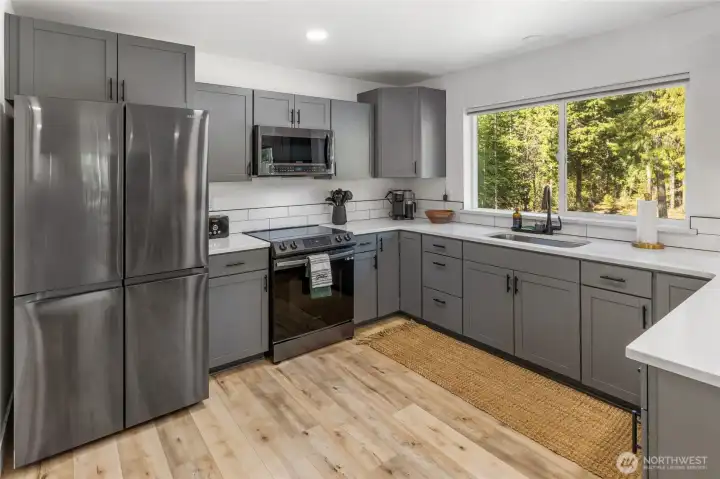 Any chef would love to prepare meals in this kitchen. Stainless steal appliances, quartz counter tops and custom cabinets.