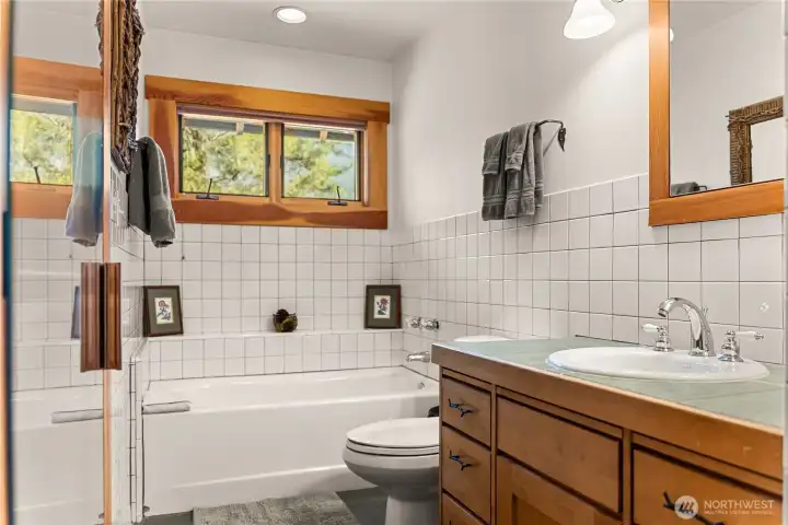 Soaking tub, shower, tiled walls, and backsplash in the primary bathroom.