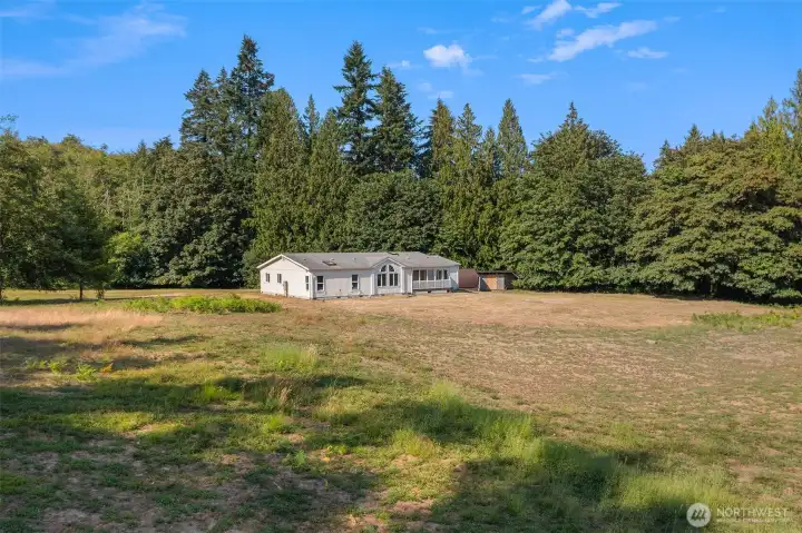 Welcome to this beautiful, sunny acreage with a generous home already on site! Ten acres of meadows and forest for you to enjoy.