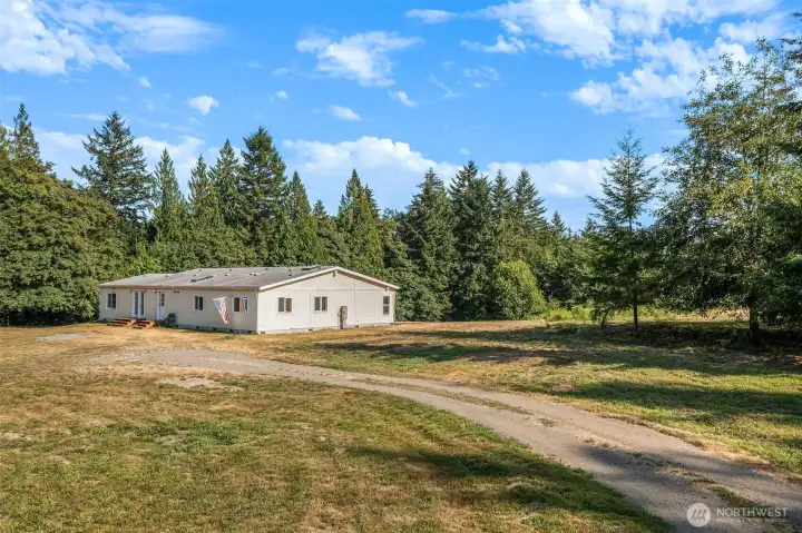 So much level ground to realize your plans. Drive right up to the house. One could build a garage, too.
