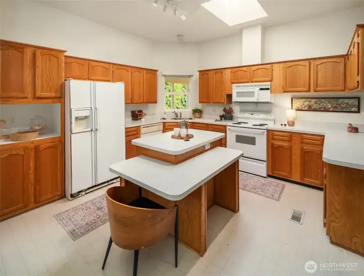Eat-in kitchen with generous island and tons of cabinetry.