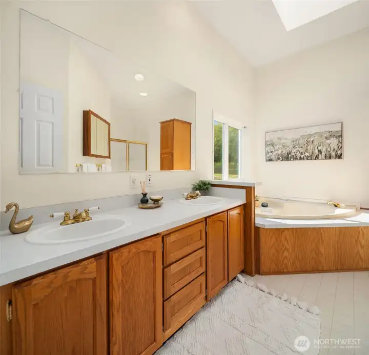 Primary bath with soaking tub and separate shower. Loads of storage!