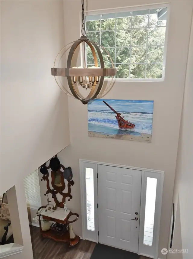 Entry w/ tall ceilings leading to the staircase.