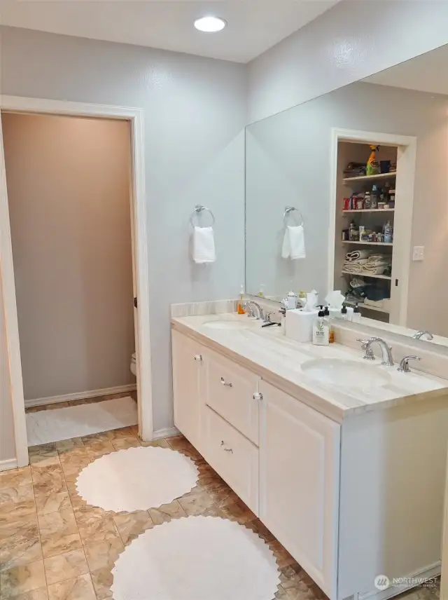 Master Bathroom w/ double vanity. Door leads to the loo.