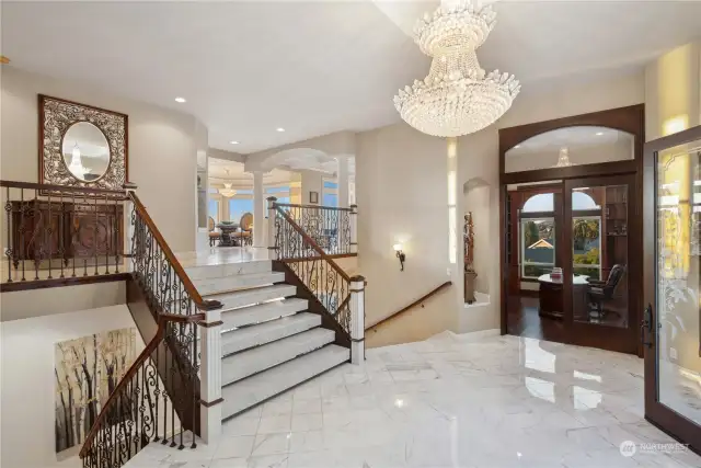 Just beyond the front doors you are greeted by marble entry,stunning chandelier &  wood clad den