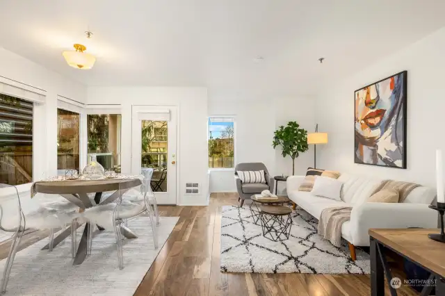 Open living and dining area with vinyl plank flooring.