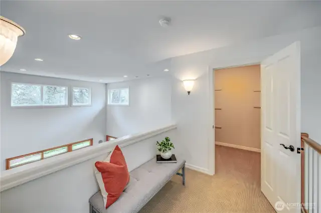Gracious landing at top of the stairway overlooks the great room and foyer.
