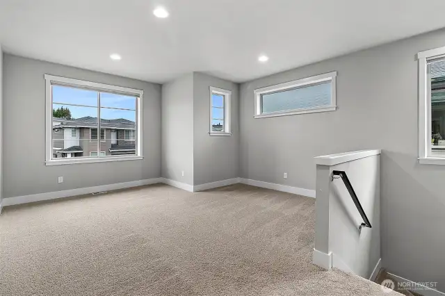 Loft brimming with possibilities-its open layout invites creativity, with ample space for relaxation, work, or play. lg windows flood the room with natural light, creating a bright and welcoming atmosphere.