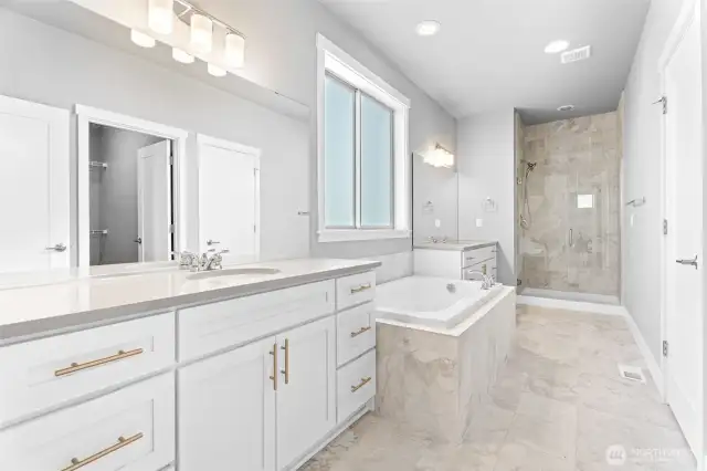 Spacious spa inspired primary bathroom, double sinks, soaking tub and frameless shower!