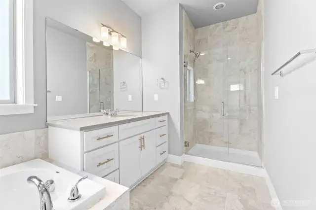 Spacious walk in shower with a frameless shower door.