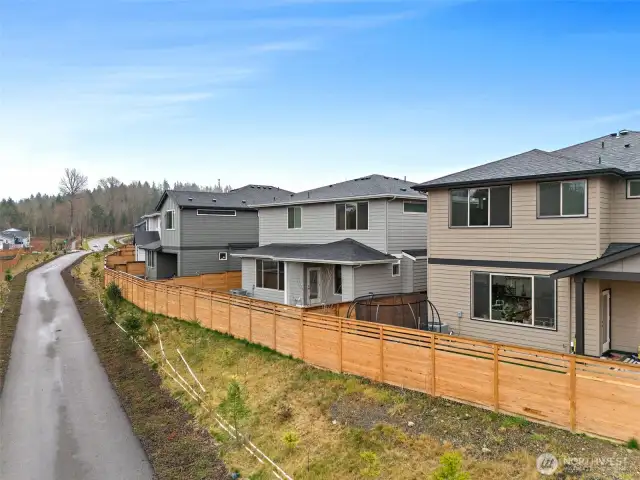 Enjoy the paved path to the trail systems conveniently located just steps away from your backyard!