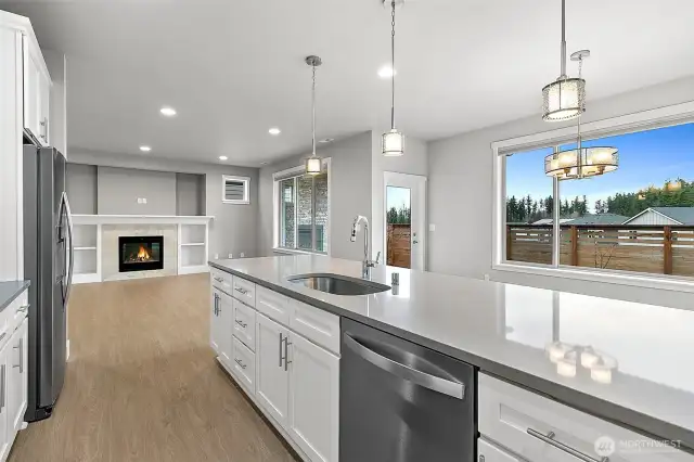 Expansive quartz island with built-in dining space, seamlessly integrated into the open-concept layout.