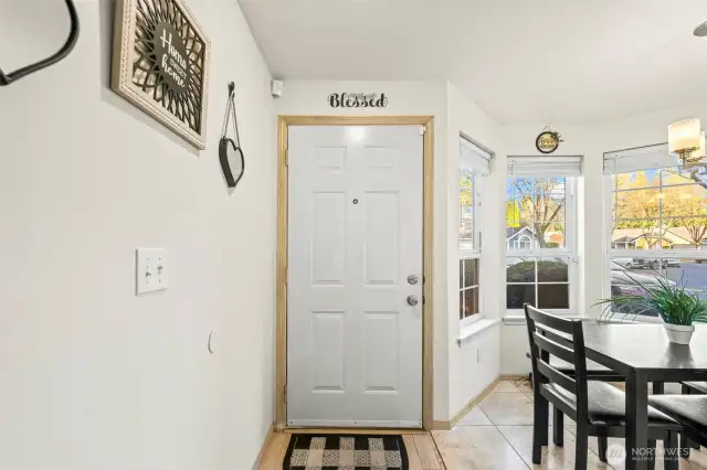 View of front door with kitchen eating nook